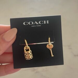Coach lock and key earrings. New with bag.